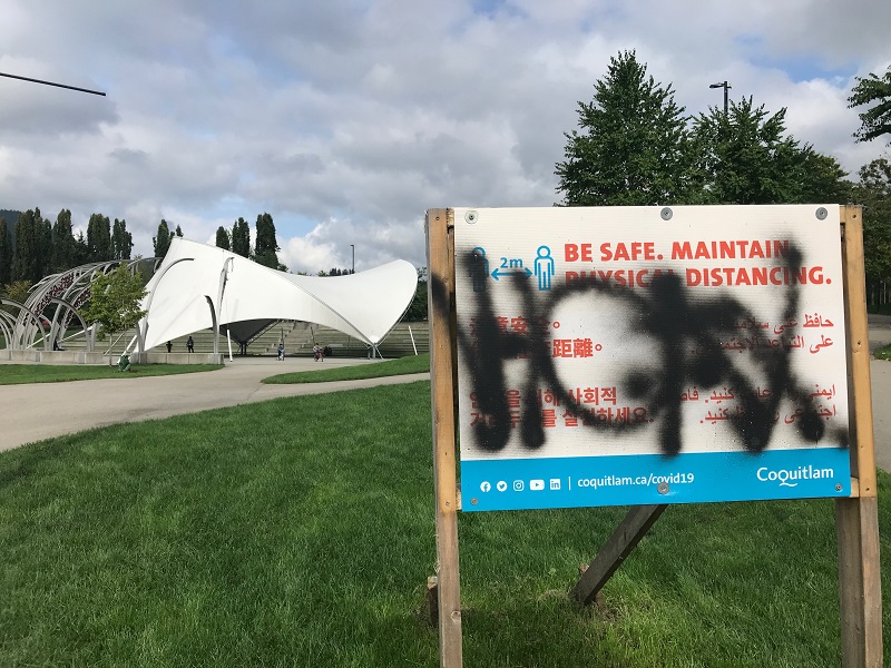 Police are searching for a suspect who allegedly vandalized signs in a Coquitlam park.