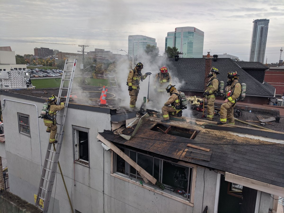 Ottawa fire crews battle a blaze on the roof of a two-storey building in Little Italy on Thursday, Oct. 22, 2020.