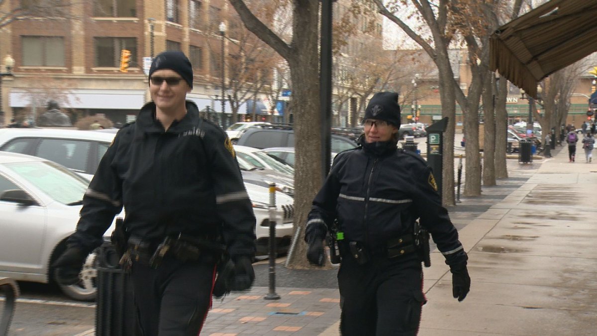 Saskatoon police officers patrol along 21st Street East on Wednesday afternoon, part of the "Downtown Public Safety Initiative.".