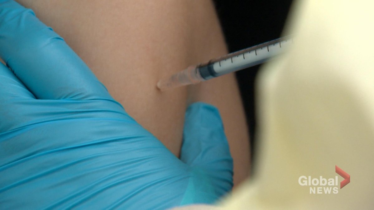 A woman receives a flu shot at the drive-thru clinic in Martensville.