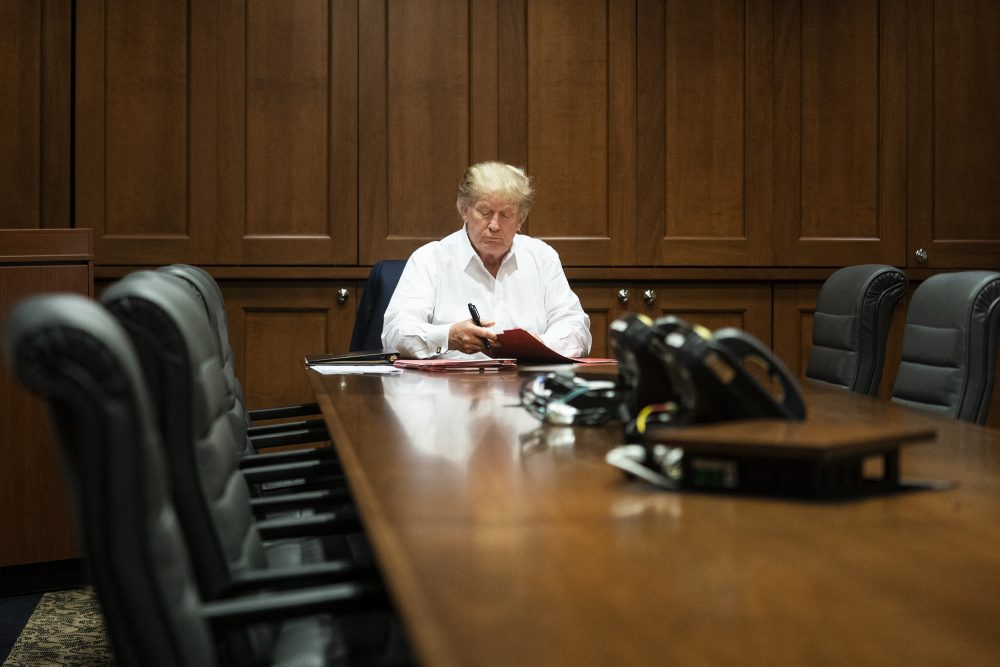 In this photo released by the White House, United States President Donald J. Trump works in his conference room at Walter Reed National Military Medical Center in Bethesda, Md., Oct. 3, 2020, after testing positive for COVID-19.