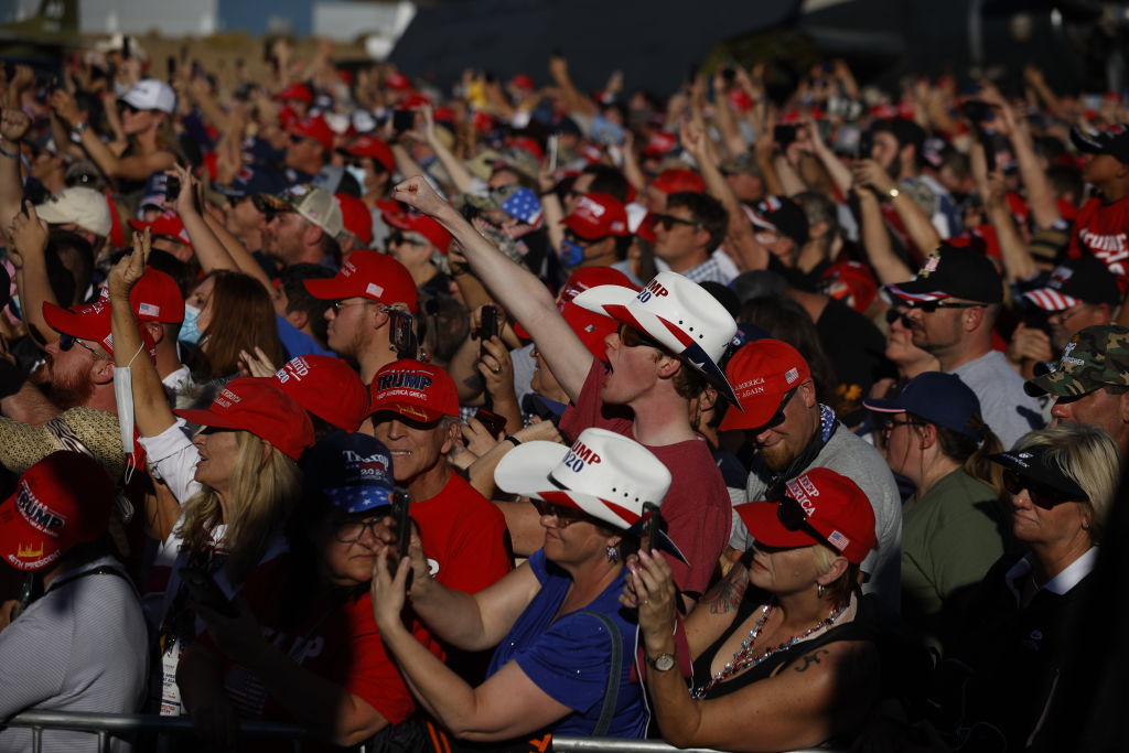 Attendees react as President Donald Trump speaks during a campaign rally on Oct. 18, 2020, in Carson City, Nev.