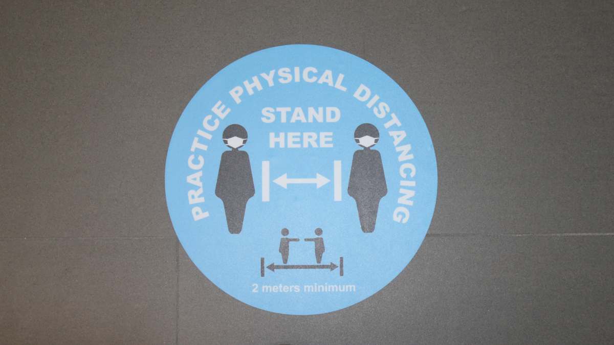 File photo of a sign about physical distancing.