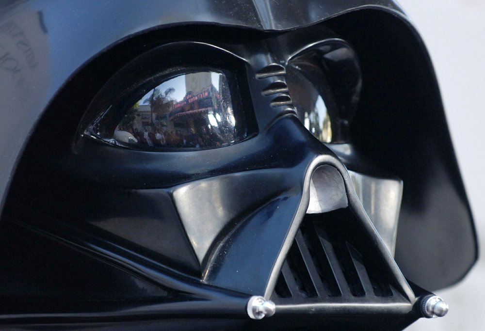  In this file photo dated Thursday, May 12, 2005, the Los Angeles, USA, premiere of the movie "Star Wars: Revenge of the Sith", is reflected in the mask eyeglasses of iconic baddie character Darth Vader. The British actor, Prowse who played Darth Vader in the original Star Wars trilogy, has died aged 85 on Saturday, according to an announcement by his agent Sunday Nov. 29, 2020.