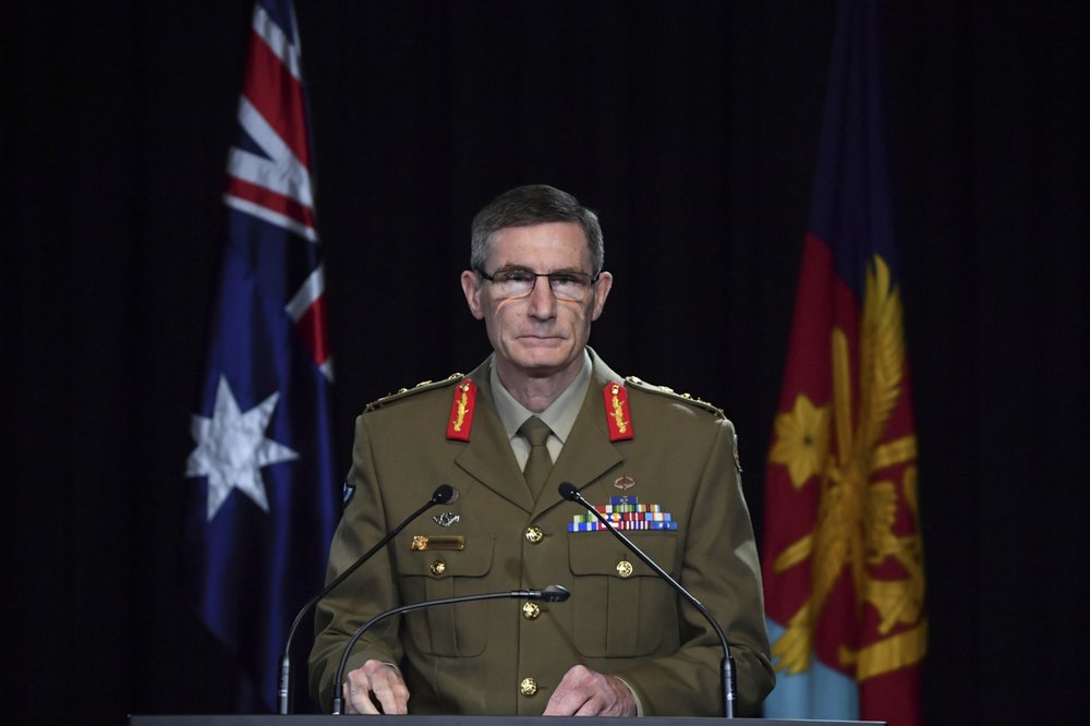 Chief of the Australian Defence Force Gen. Angus Campbell delivers the findings from the Inspector-General of the Australian Defence Force Afghanistan Inquiry, in Canberra, Thursday, Nov. 19, 2020. A shocking report into war crimes by elite Australian troops has found evidence that 25 soldiers unlawfully killed 39 Afghan prisoners, farmers and civilians. 