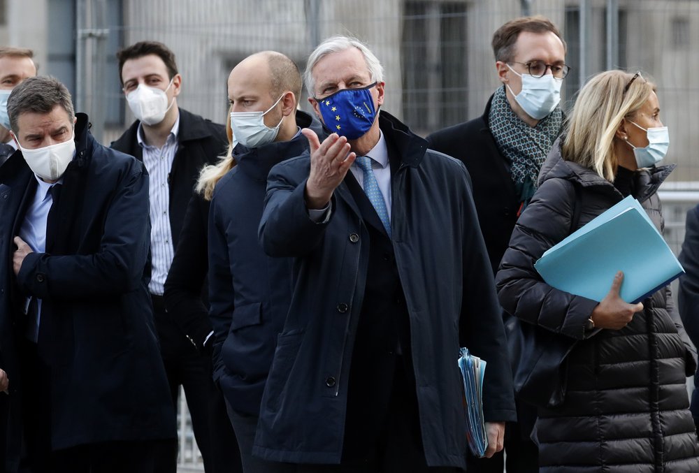 FILE - In this file photo dated Thursday, Nov. 12, 2020, European Commission's Head of Task Force for Relations with the United Kingdom Michel Barnier, centre, leaves the Conference Centre in London with unidentified members of his team. The Brexit trade negotiations have been suspended Thursday Nov. 19, 2020, at a crucial stage because an EU negotiator has tested positive for the coronavirus and EU chief negotiator Michel Barnier said that “we have decided to suspend the negotiations at our level for a short period.” .