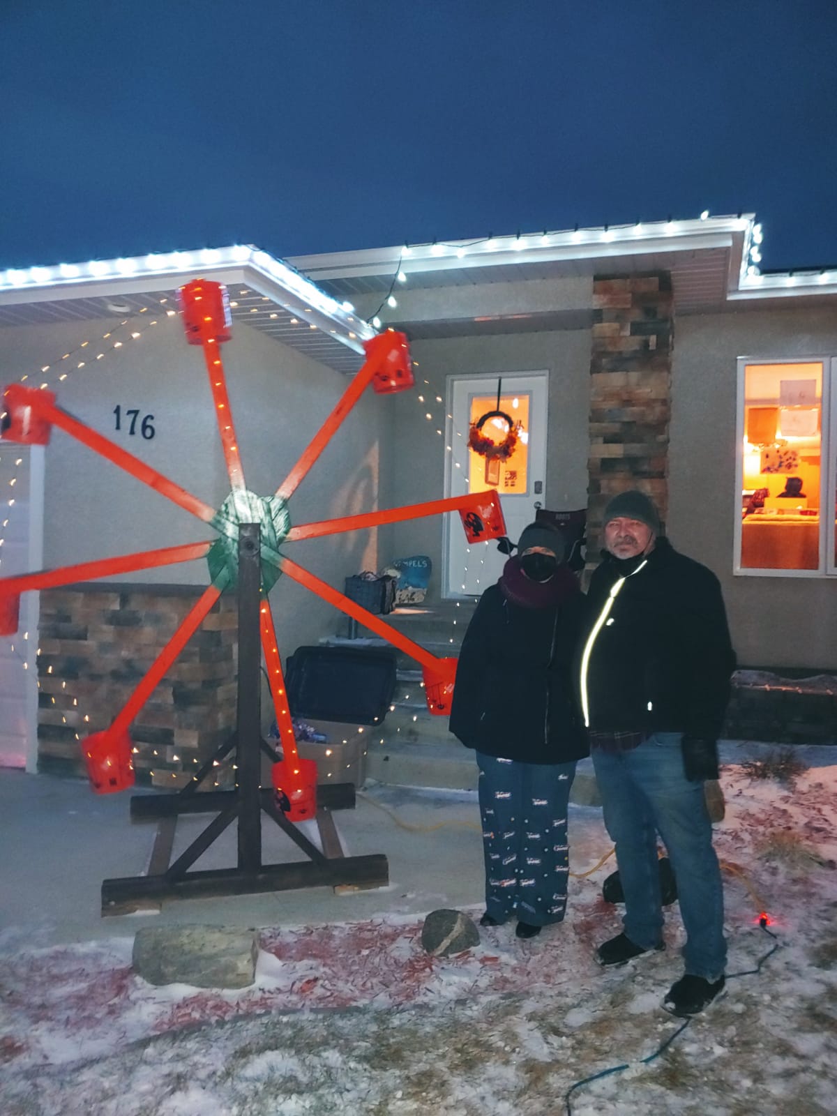 Jake Rempel standing with his homemade Halloween ferris wheel.