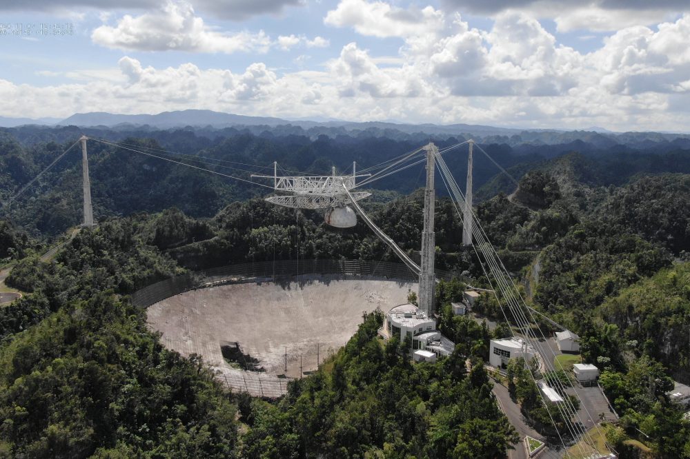 The Arecibo Observatory is shown with a large hole in its telescope dish in November 2020.