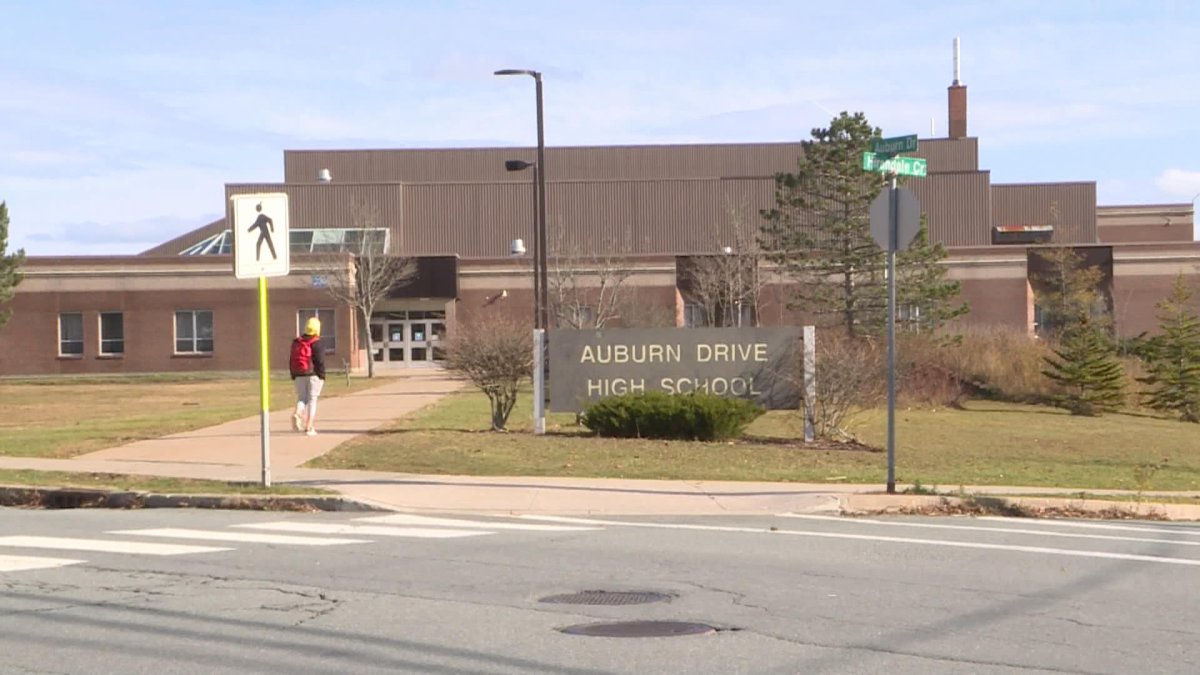 A student walks to Auburn Drive High School after a COVID case was confirmed at the school.
