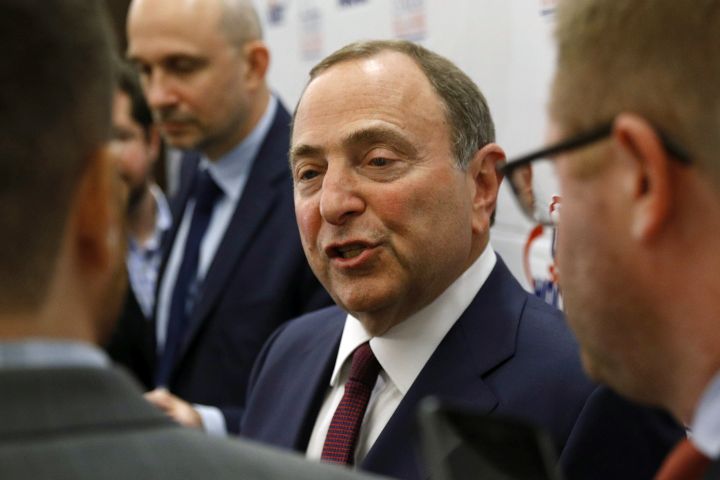 FILE - In this Dec. 12, 2019, file photo, NHL Commissioner Gary Bettman speaks with members of the media before being inducted into the U.S. Hockey Hall of Fame in Washington. 