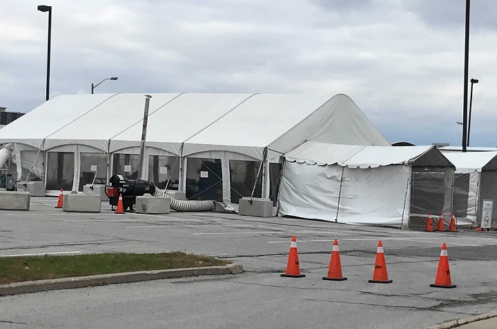 Crews are working to repair the tent, which was damaged by wind.