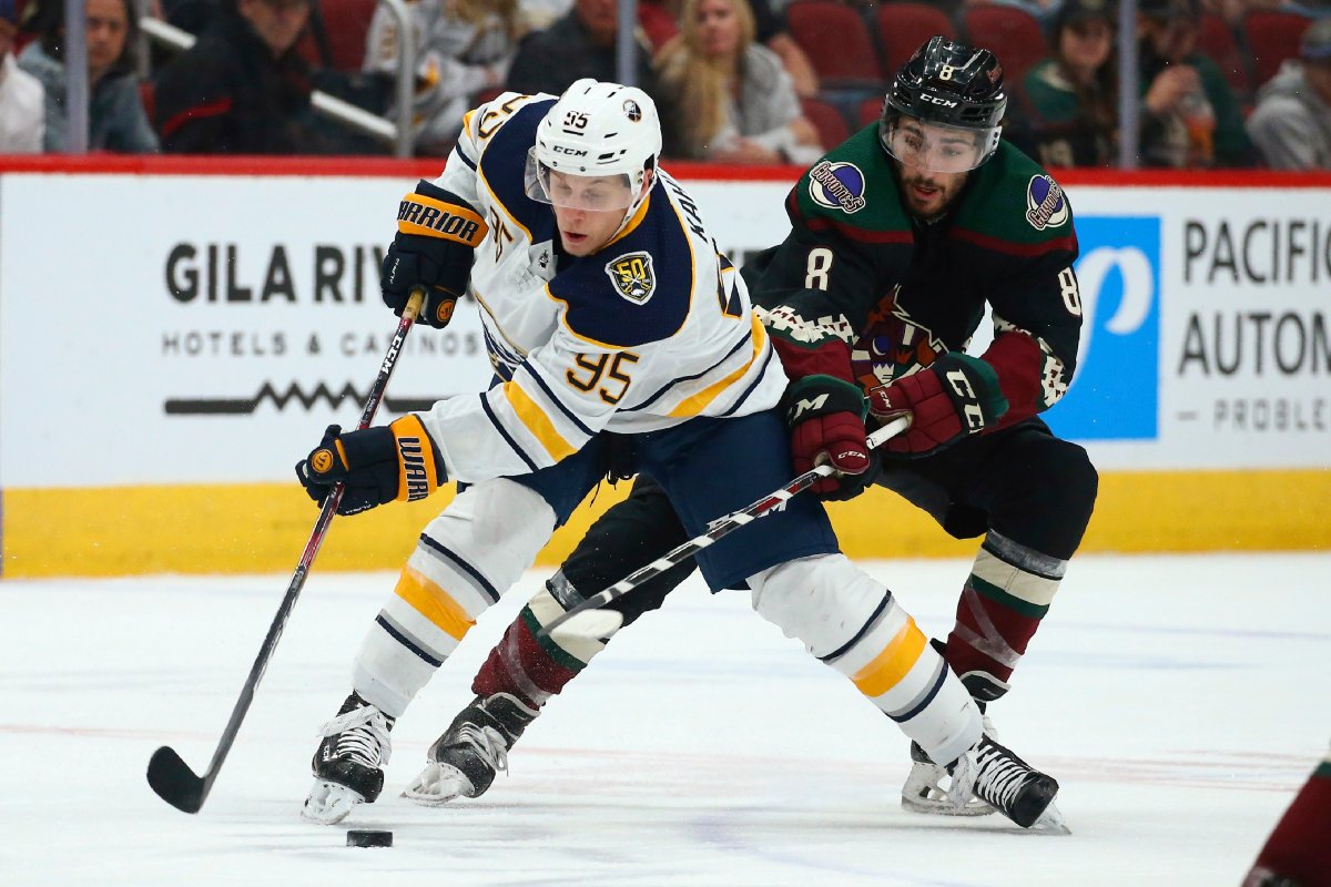 FILE - In this Feb. 29, 2020, file photo, Buffalo Sabres center Dominik Kahun (95) tries to keep the puck away from Arizona Coyotes center Nick Schmaltz (8) during an NHL hockey game in Glendale, Ariz.  (AP Photo/Ross D. Franklin, File).