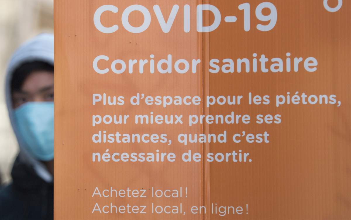People wear face masks as they walk along a street in Montreal, Saturday, Oct. 31, 2020, as the COVID-19 pandemic continues in Canada and around the world. 