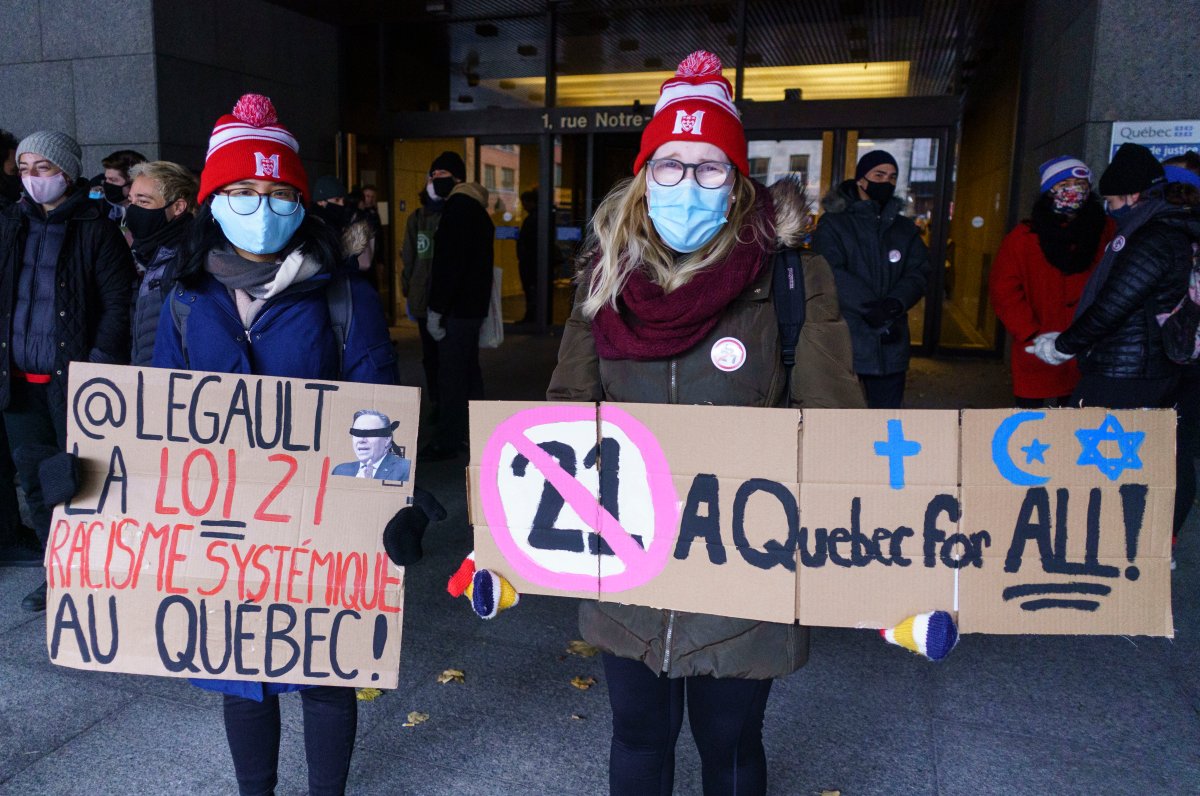 Demonstrators stand outside the courthouse on the first day of the constitutional challenge to Bill 21, which bans public workers in positions of "authority" from wearing religious symbols,  before the Quebec Superior Court in Montreal on Monday, November 2, 2020. THE CANADIAN PRESS/Paul Chiasson.