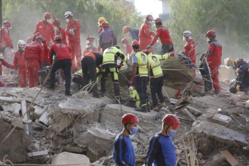 Members of rescue services search for survivors in the debris of a collapsed building in Izmir, Turkey, Monday, Nov. 2, 2020.
