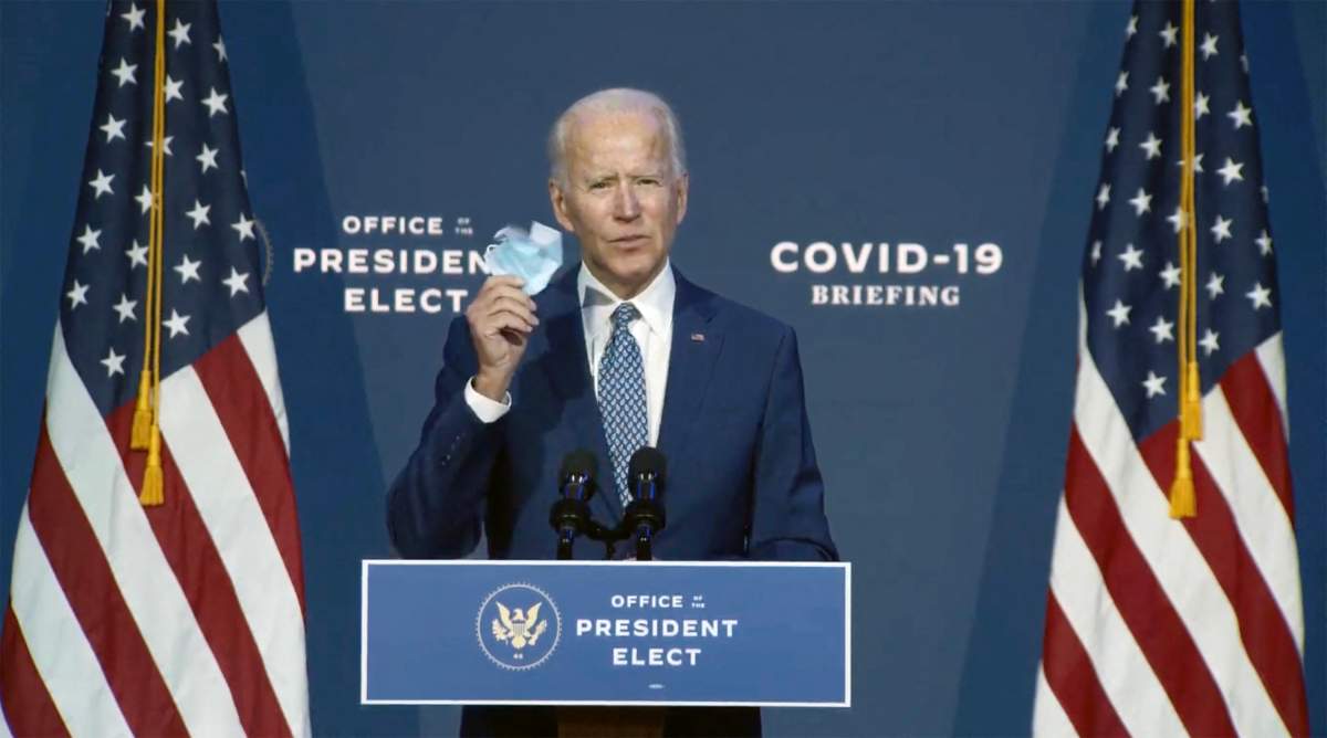 In this image from the Biden Presidential Transition video feed, United States President-elect Joe Biden holds a mask as he makes a statement after meeting with his newly-appointed twelve member task force to combat the Covid-19 crisis in Wilmington, DE, USA, on Friday, November 6, 2020.
