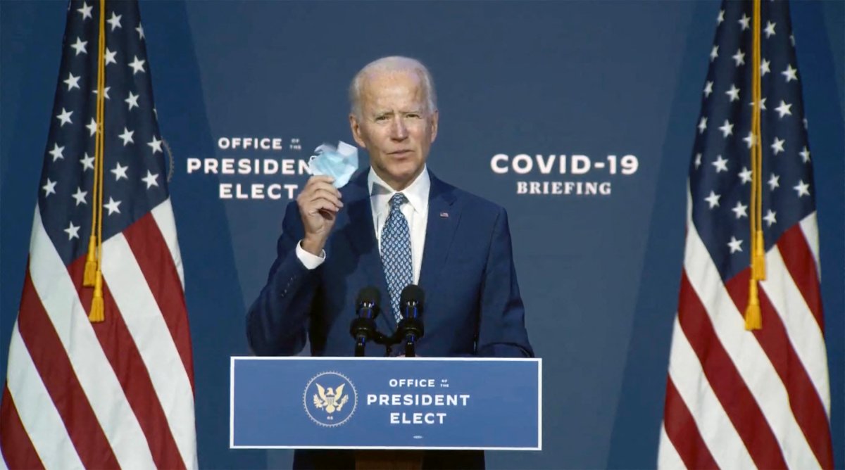 In this image from the Biden Presidential Transition video feed, United States President-elect Joe Biden holds a mask as he makes a statement after meeting with his newly-appointed twelve member task force to combat the Covid-19 crisis in Wilmington, DE, USA, on Friday, November 6, 2020.