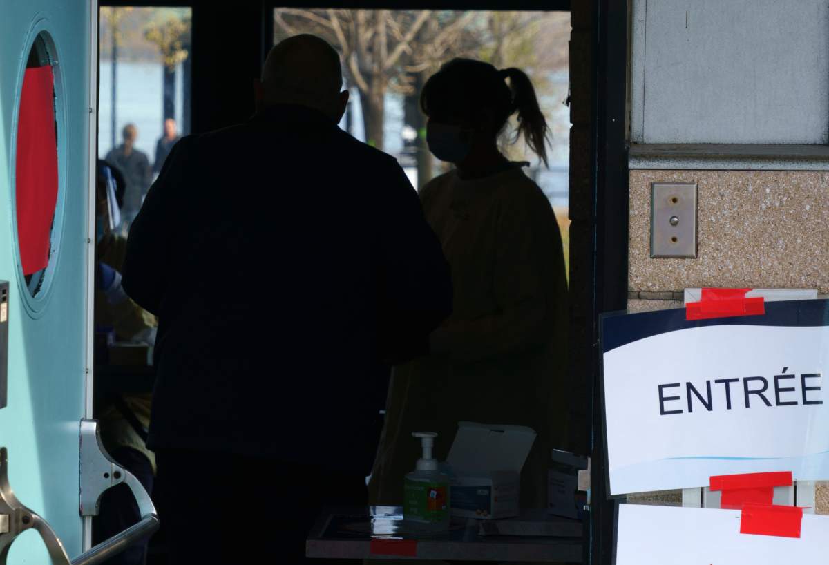 A nurse welcomes a man at a COVID-19 testing clinic in Montreal, on Monday, November 9, 2020. 