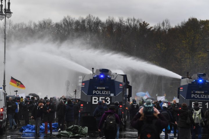Police fire water cannons at demonstrators protesting coronavirus restrictions in Berlin