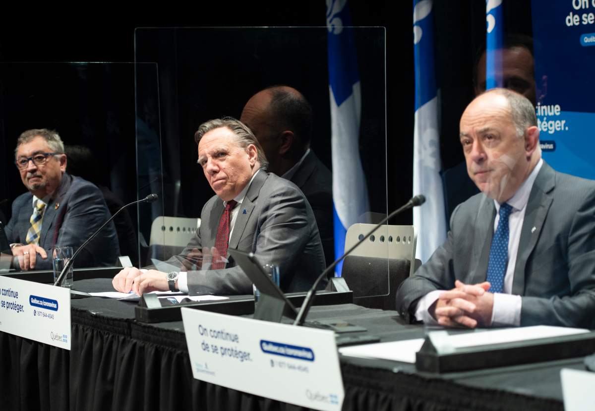 Quebec Public Health Director Horacio Arruda, left to right, Quebec Premier Francois Legault and Health Minister Christian Dube speak to the media at the COVID-19 press briefing in Montreal, Thursday, Nov. 19, 2020. THE CANADIAN PRESS/Ryan Remiorz.
