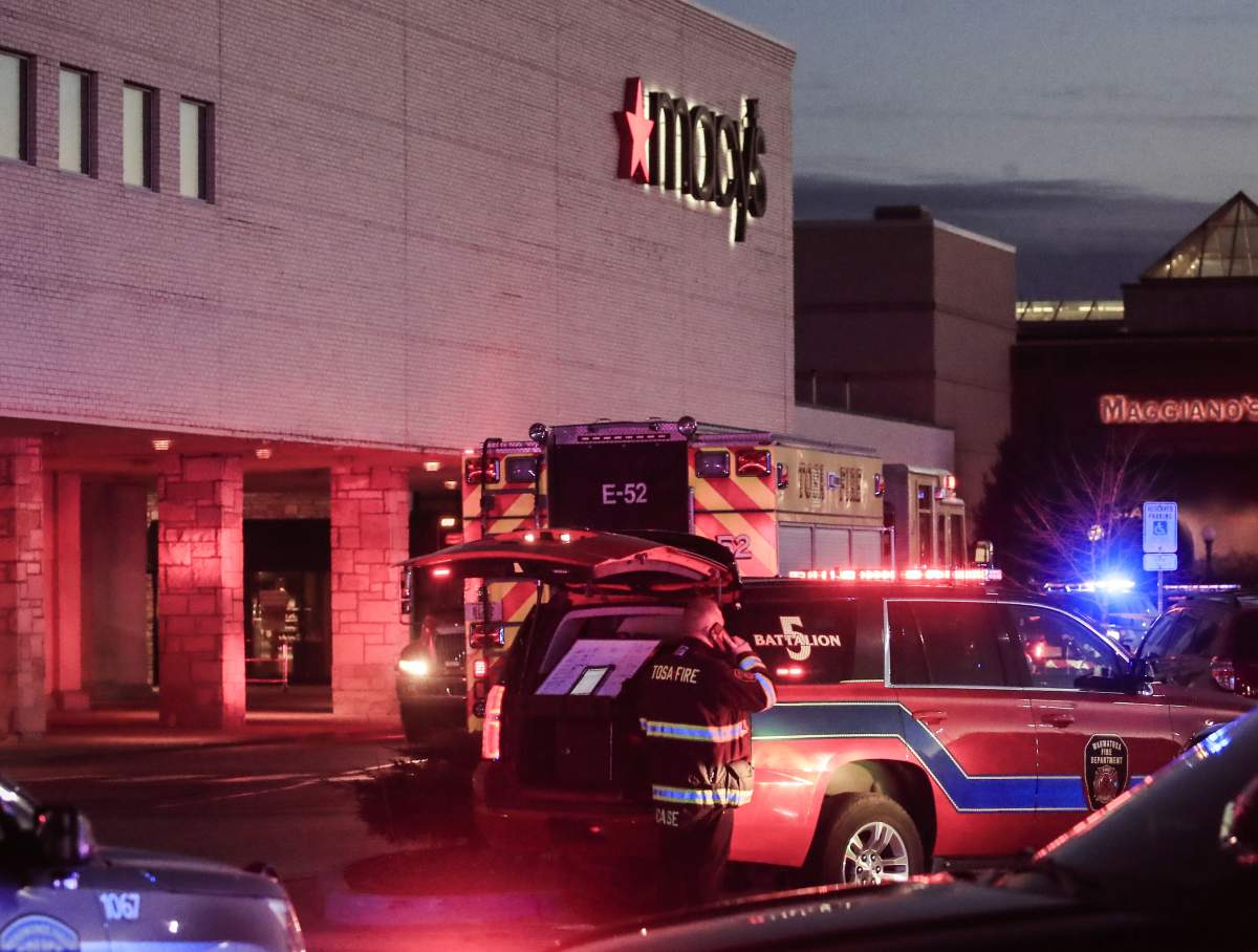 Emergency personnel stand outside after reports of multiple people shot at the Macy's department store in the MayFair Mall in Wauwatosa, Wisconsin, Nov. 20, 2020.