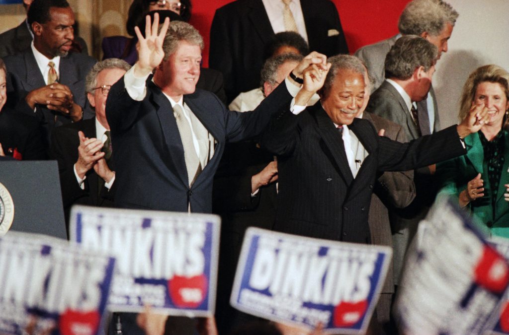 FILE – In this Thursday, Oct. 28, 1993, file photo, President Bill Clinton holds up four fingers signifying four more years as he appears at a Democratic Unity Rally in support of Mayor David Dinkins, right, in New York. Dinkins, New York City’s first African-American mayor, died Monday, Nov. 23, 2020. He was 93. (AP Photo/Ron Frehm, File)