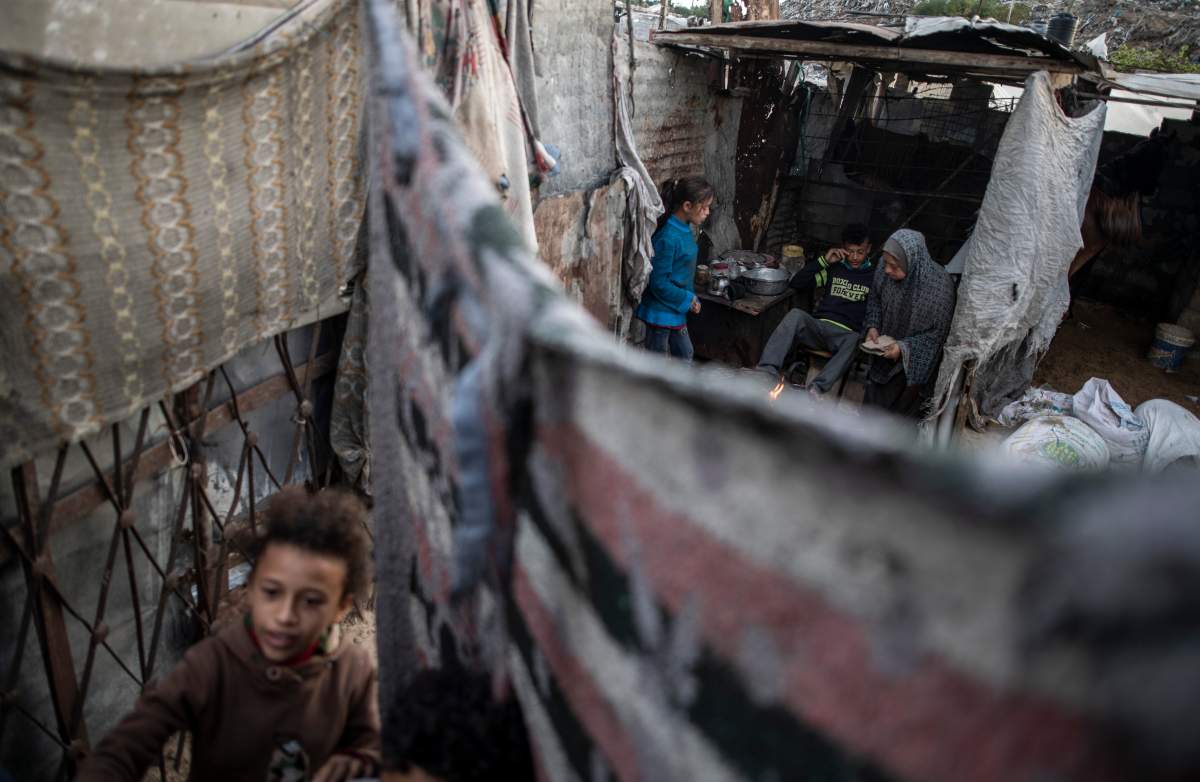 A Palestinian family prepares tea in their house in a slum on the outskirts of Khan Younis Refugee Camp, in the southern Gaza Strip,  Nov. 25, 2020.