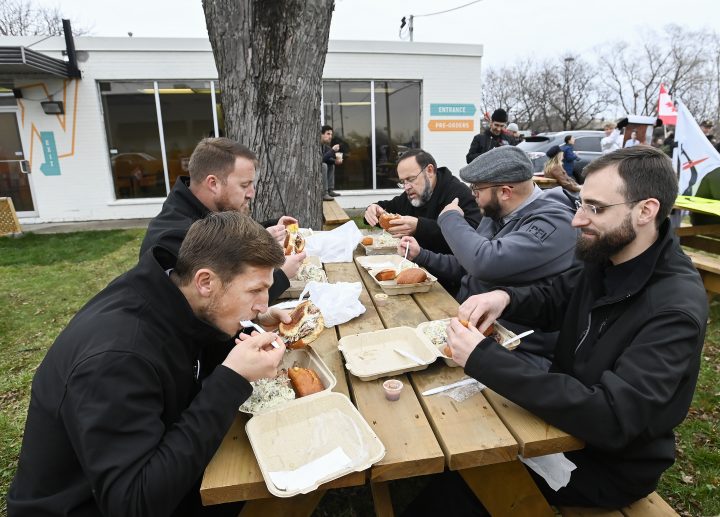 People enjoy their food at Adamson Barbecue as the restaurant and people defy provincial lockdown orders to shut down indoor and outdoor dining during the COVID-19 pandemic in Toronto on Wednesday, November 25, 2020.