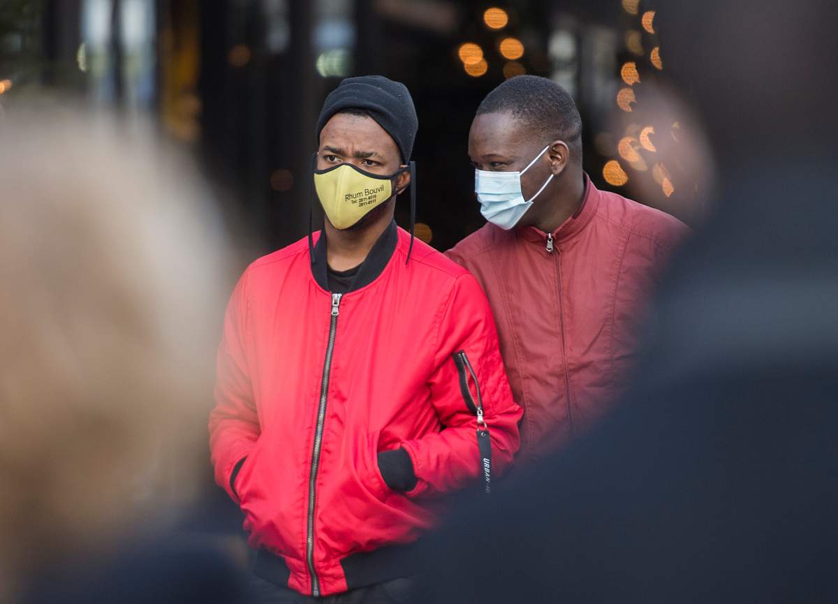 People wear face masks as they walk along a street in Montreal, Sunday, Nov. 29, 2020, as the COVID-19 pandemic continues in Canada and around the world.
