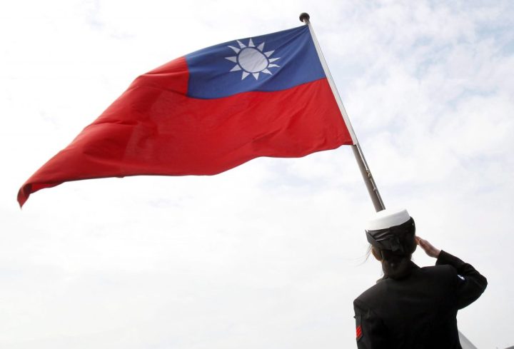 A Taiwanese military officer salutes to Taiwan's flag onboard Navy's 124th fleet Lafayette frigate during military exercises off Kaohsiung, southern of Taiwan, Wednesday, Jan. 31, 2018. 