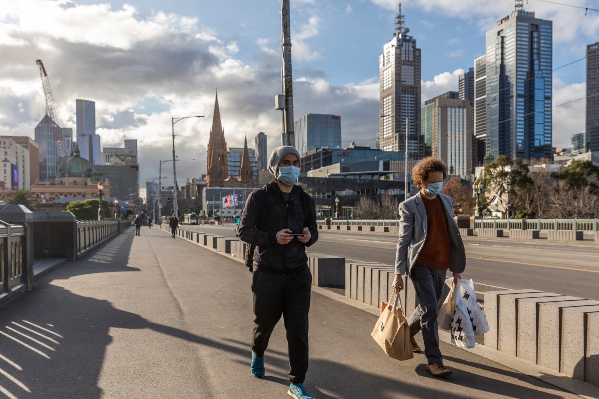 Pedestrians walk away from the central business district as lockdown due to the continuing spread of the coronavirus starts in Melbourne, Wednesday, Aug. 5, 2020.