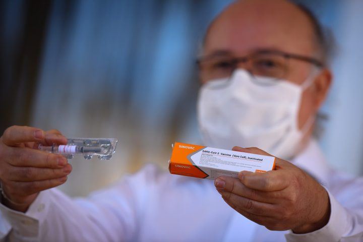 Gustavo Romero, Professor of Medicine, who coordinates research on the coronavirus vaccine (COVID-19) in Brazil, shows a dose of a coronavirus vaccine. Manitoba will begin inoculating healthcare workers over the age of 50 next week. 