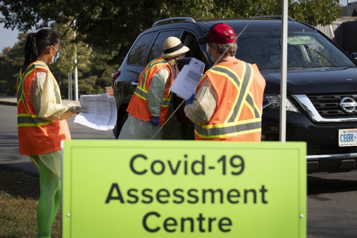 Staff talk people in their vehicle at the drive-thru COVID-19 assessment centre in Kingston, Ontario on Saturday, September 26, 2020.