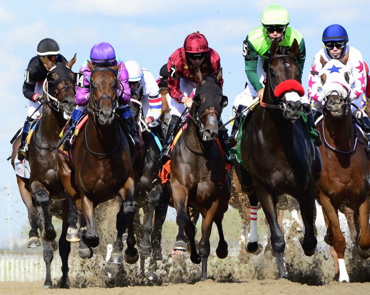 One Bad Boy, second from right, ridden by jockey Flavien Prat, rides in the pack on his way to win the Queen's Plate at Woodbine Racetrack, in Toronto on Saturday, June 29, 2019.
