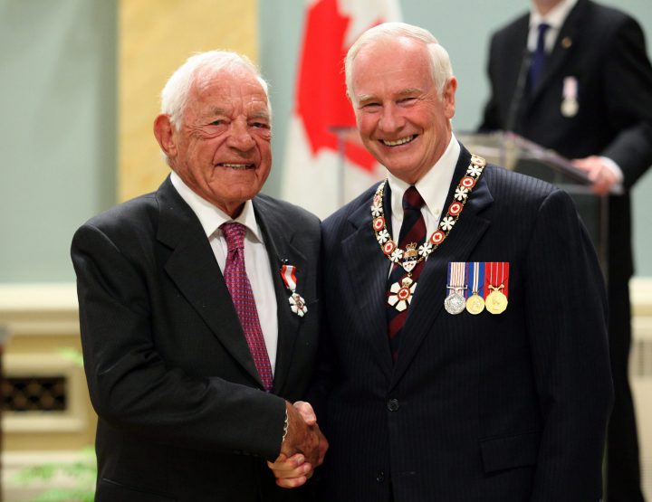 Governor General David Johnston (right) presents the Order of Canada to long-time hockey player and commentator Howie Meeker at Rideau Hall in Ottawa on Friday, May 27, 2011. 