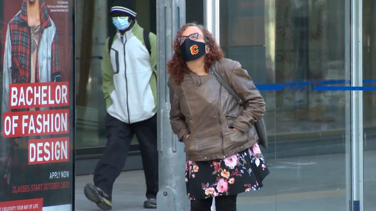 People wearing face masks are seen in downtown Calgary