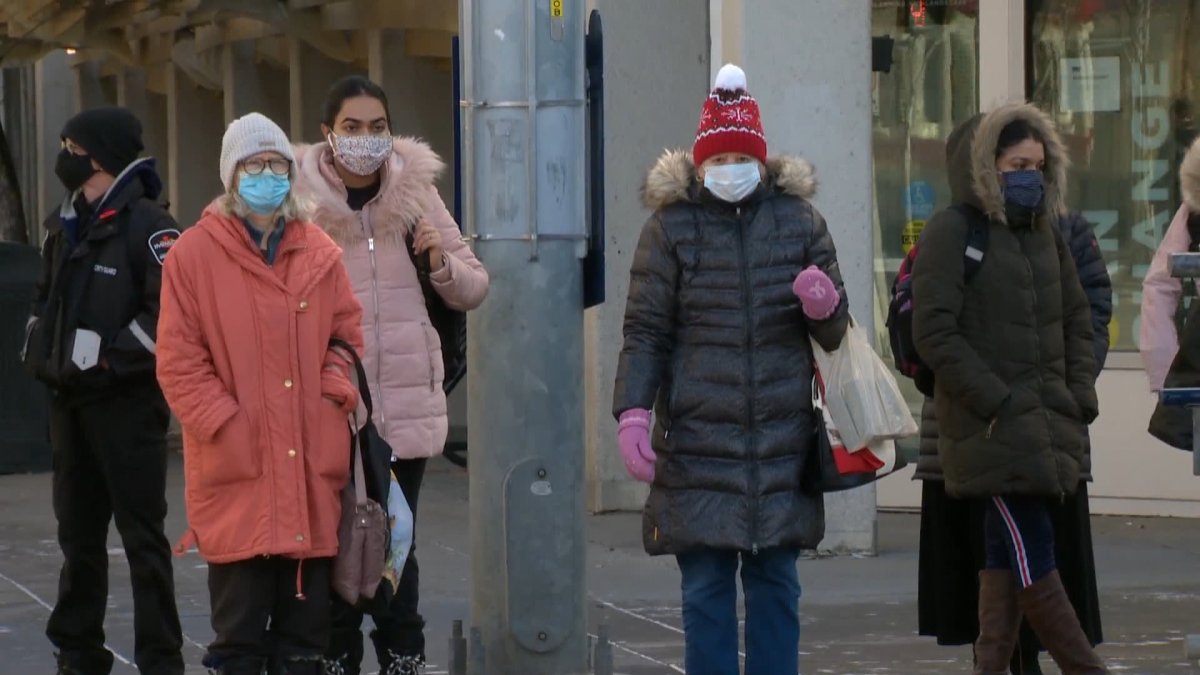 People wearing face masks are seen in downtown Calgary. 