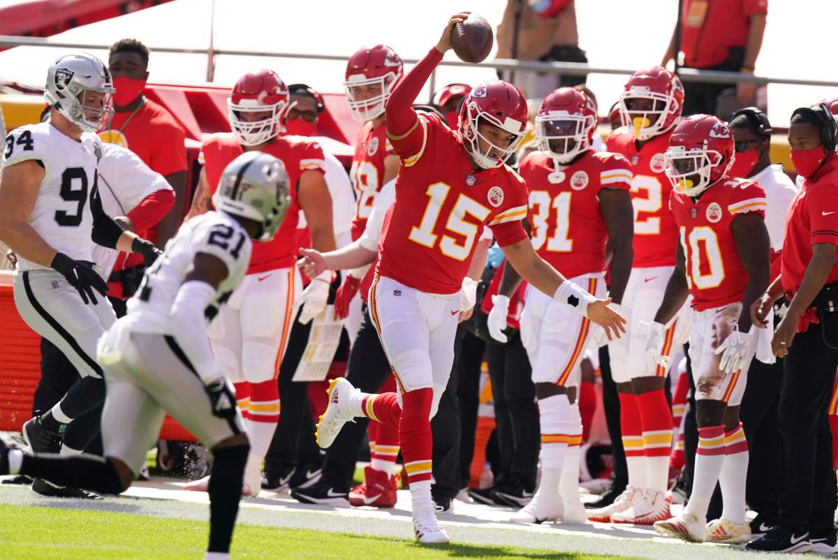 Kansas City Chiefs quarterback Patrick Mahomes (15) runs from Las Vegas Raiders cornerback Amik Robertson (21) during the first half of an NFL football game, Sunday, Oct. 11, 2020, in Kansas City.