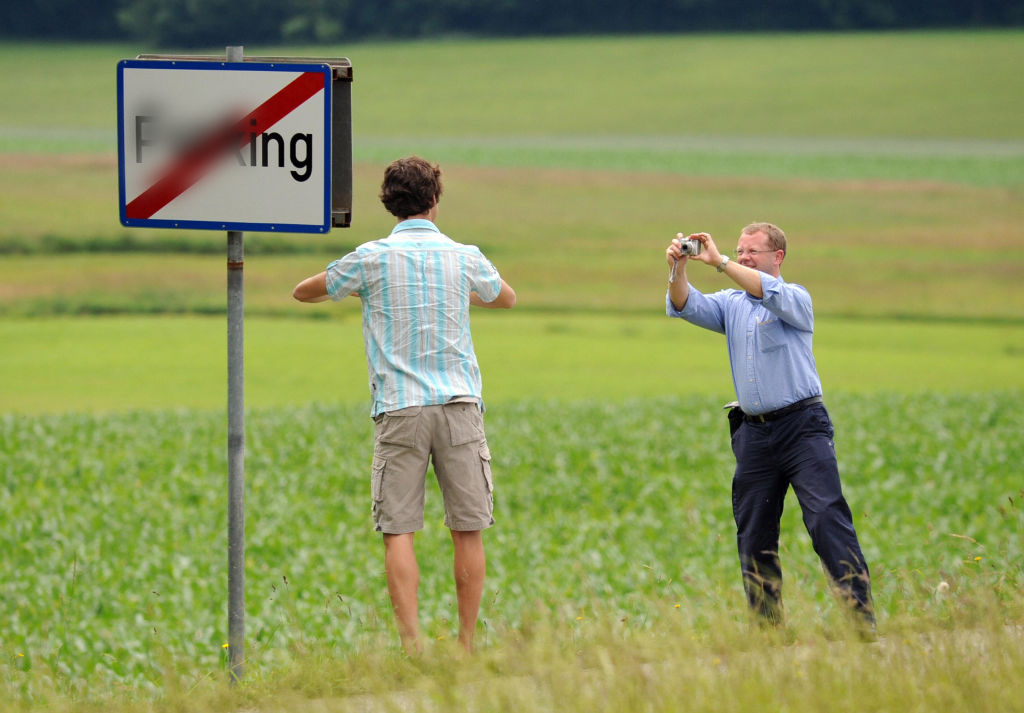 In this censored file photo, tourists take photos with the town sign on June 18, 2008.