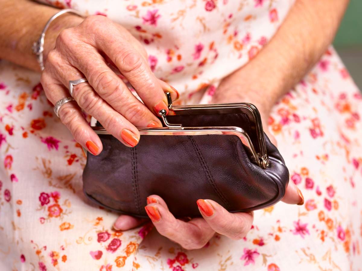 File photo of a 70-year-old woman opening a purse.