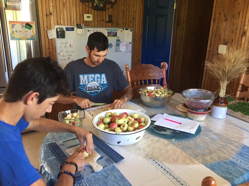 Two of Lexie Spahich’s children help prepare apples to make preserves.