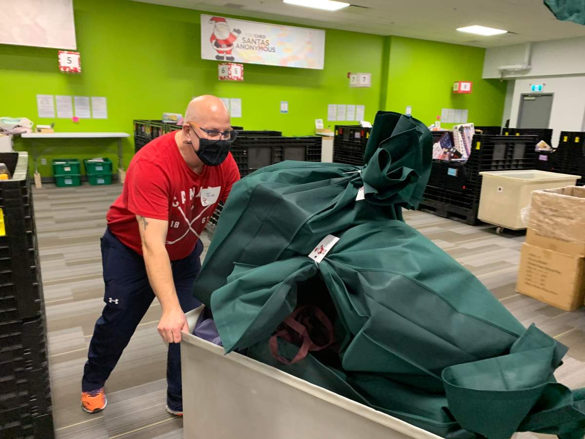 A volunteer working at 630 CHED Santas Anonymous.