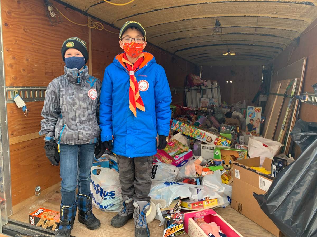Brothers Bentley and Connor Topilko pose with the toys they collected for 630 CHED Santas Anonymous.