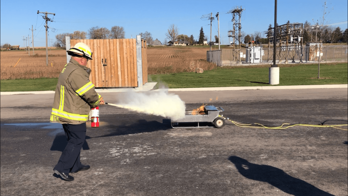 Malahide Township Fire Chief Brent Smith demonstrates proper use of a fire extinguisher.