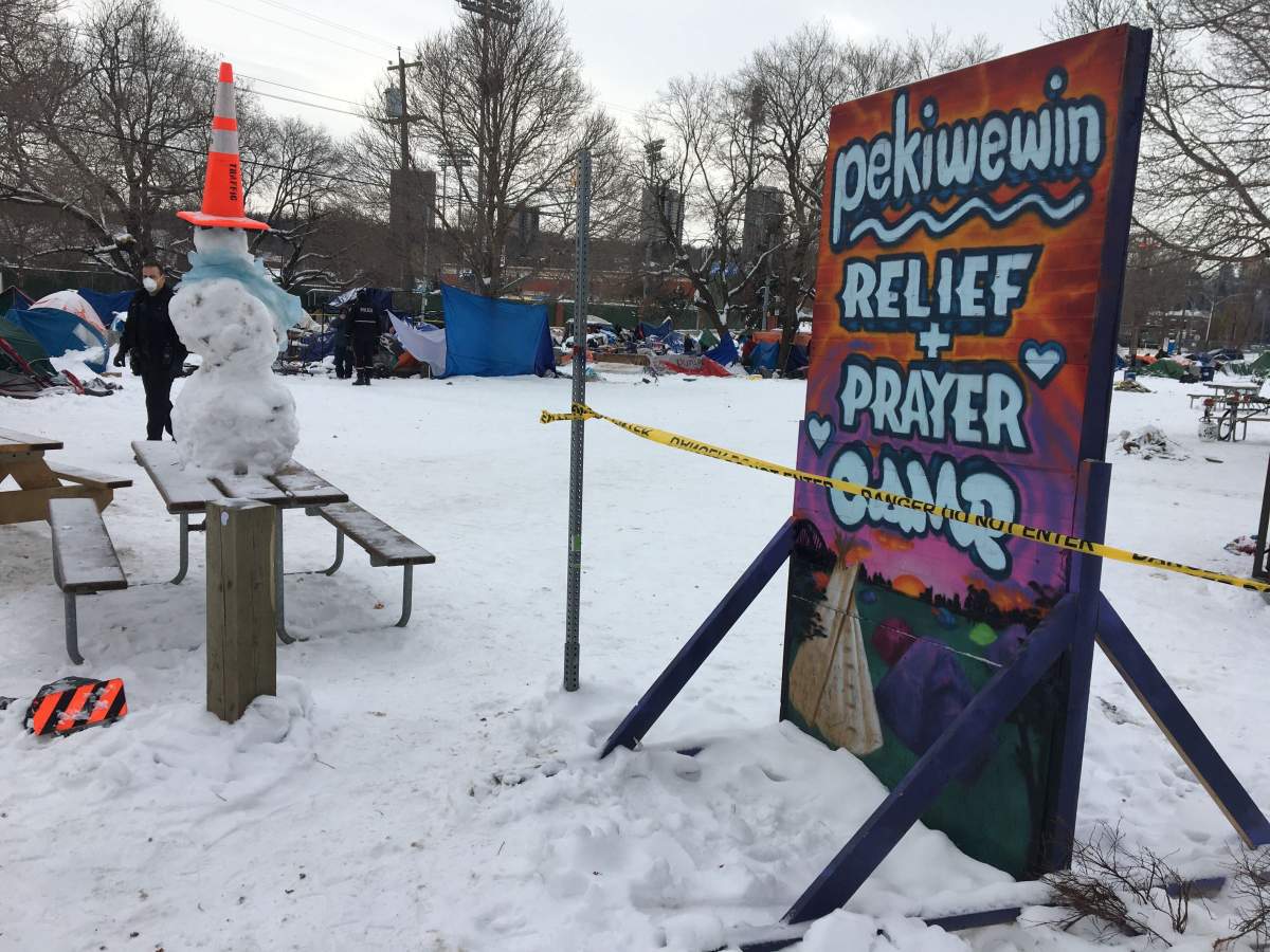 Edmonton police and peace officers at Camp Pekiwewin in the Rossdale neighbourhood Thursday, Nov. 12, 2020.