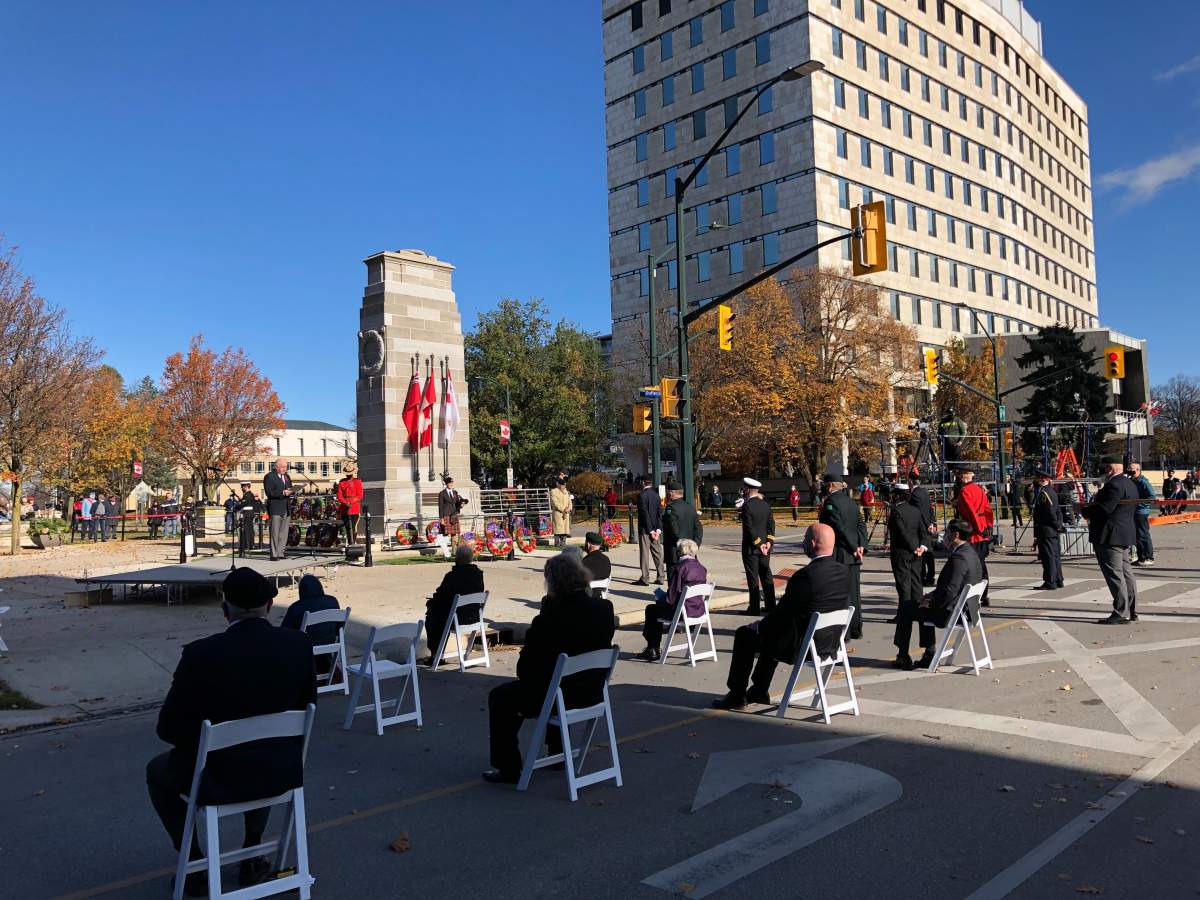 Participants sit physically distanced as the City of London holds a Remembrance Day ceremony amid the COVID-19 pandemic.