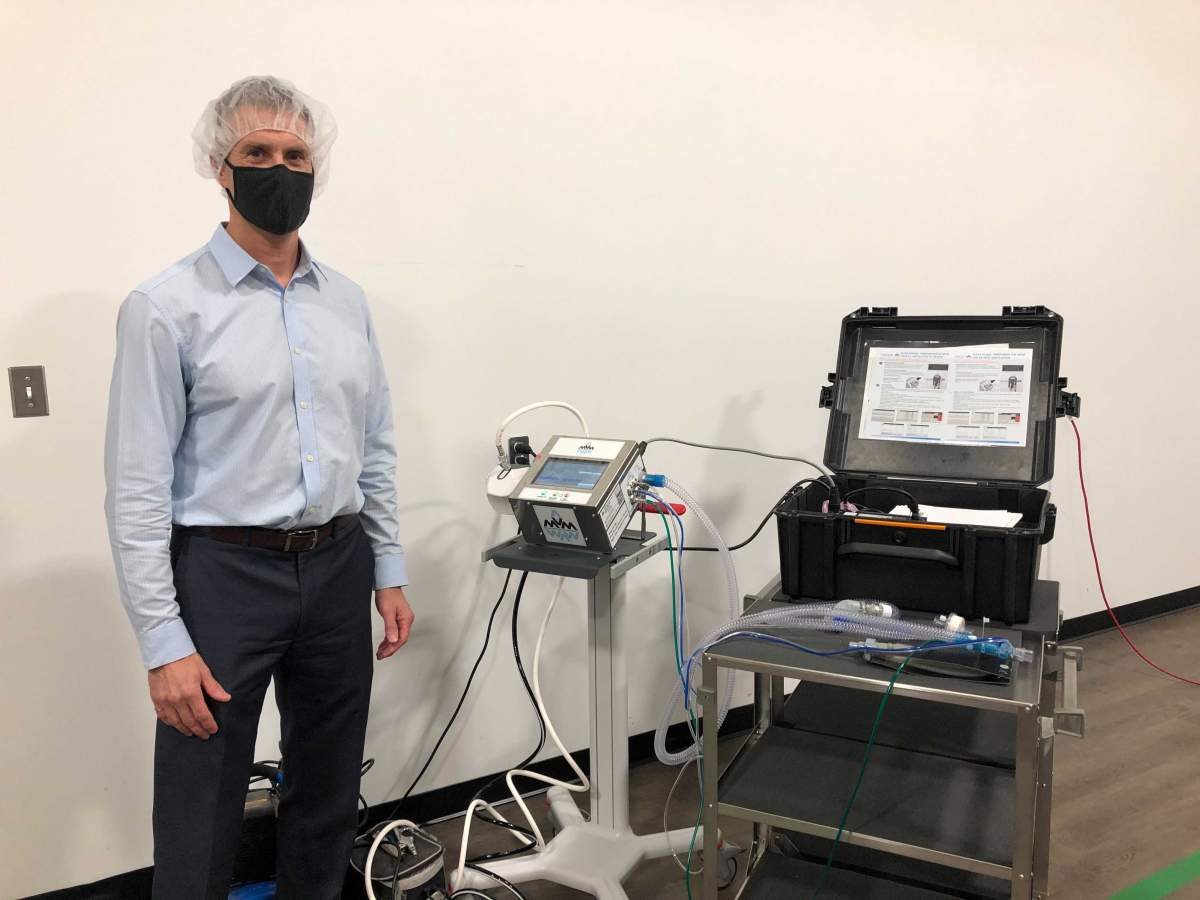 JMP Solutions president and CEO Scott Shawyer stands next to a Mechanical Ventilator Milano (MVM) ventilator that was assembled in London, Ont.