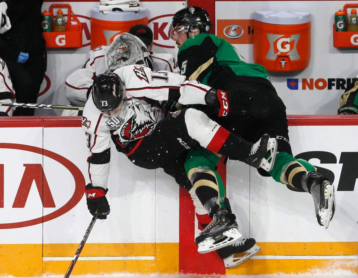 Prince Albert Raiders' Zack Hayers (5) and Rouyn-Noranda Huskies' Jakoub Lauko collide during Memorial Cup hockey action in Halifax, Monday, May 20, 2019.