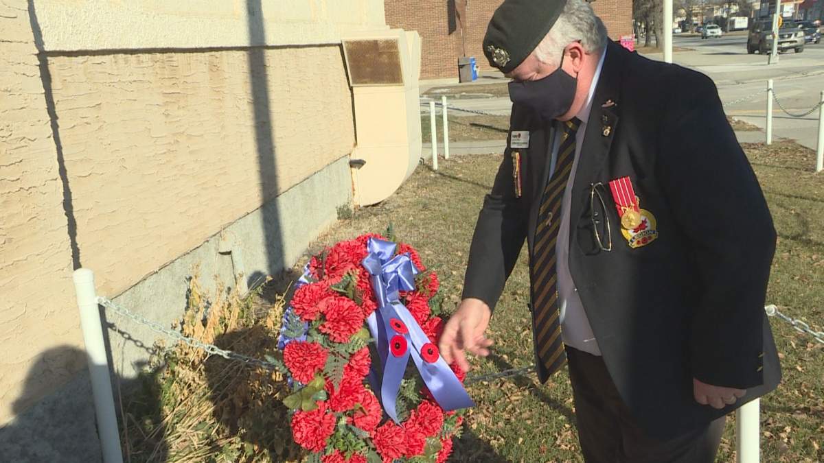 West Kildonan legion branch 30 president Stephane Guindon adds a poppy to the wreath outside the legion on Main Street on Remembrance Day.