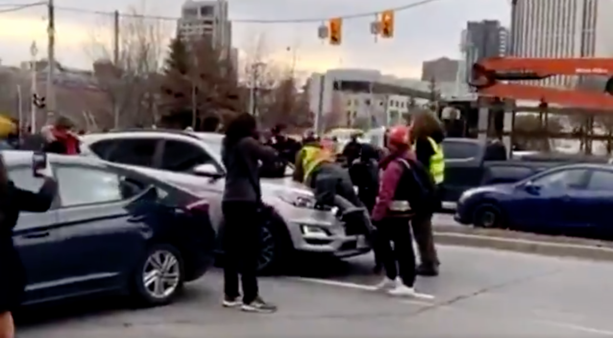 A screengrab of a video posted to Twitter showing a vehicle driving through a crowd of protesters in Ottawa on Thursday, Nov. 19, 2020.